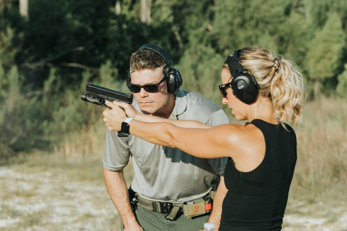 Instructor introducing firearm safety fundamentals in a no-shoot intro class