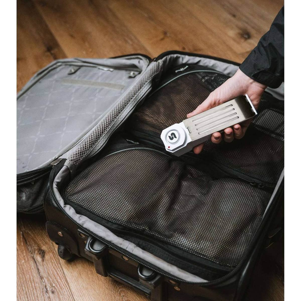 SABRE door stop alarm being packed into a carry-on suitcase for travel
